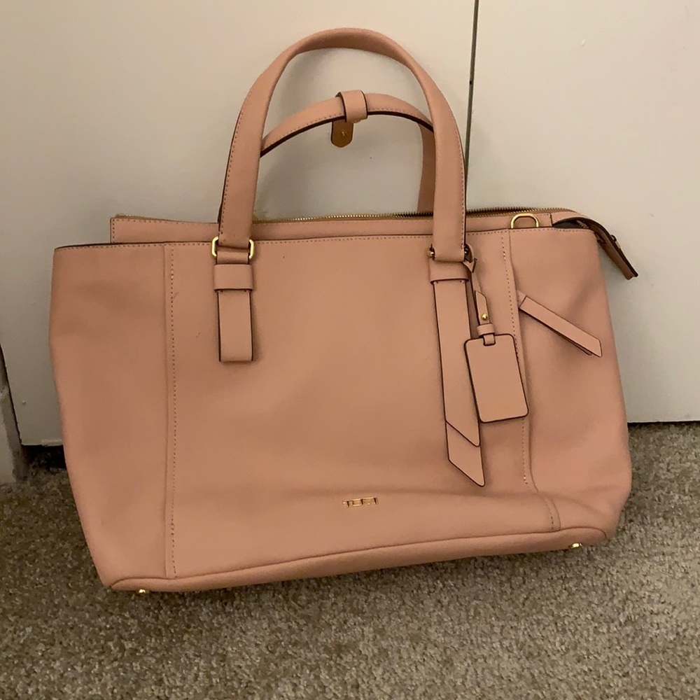 Tumi pink travel bag with luggage handle slip